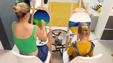mother and daughter painting together