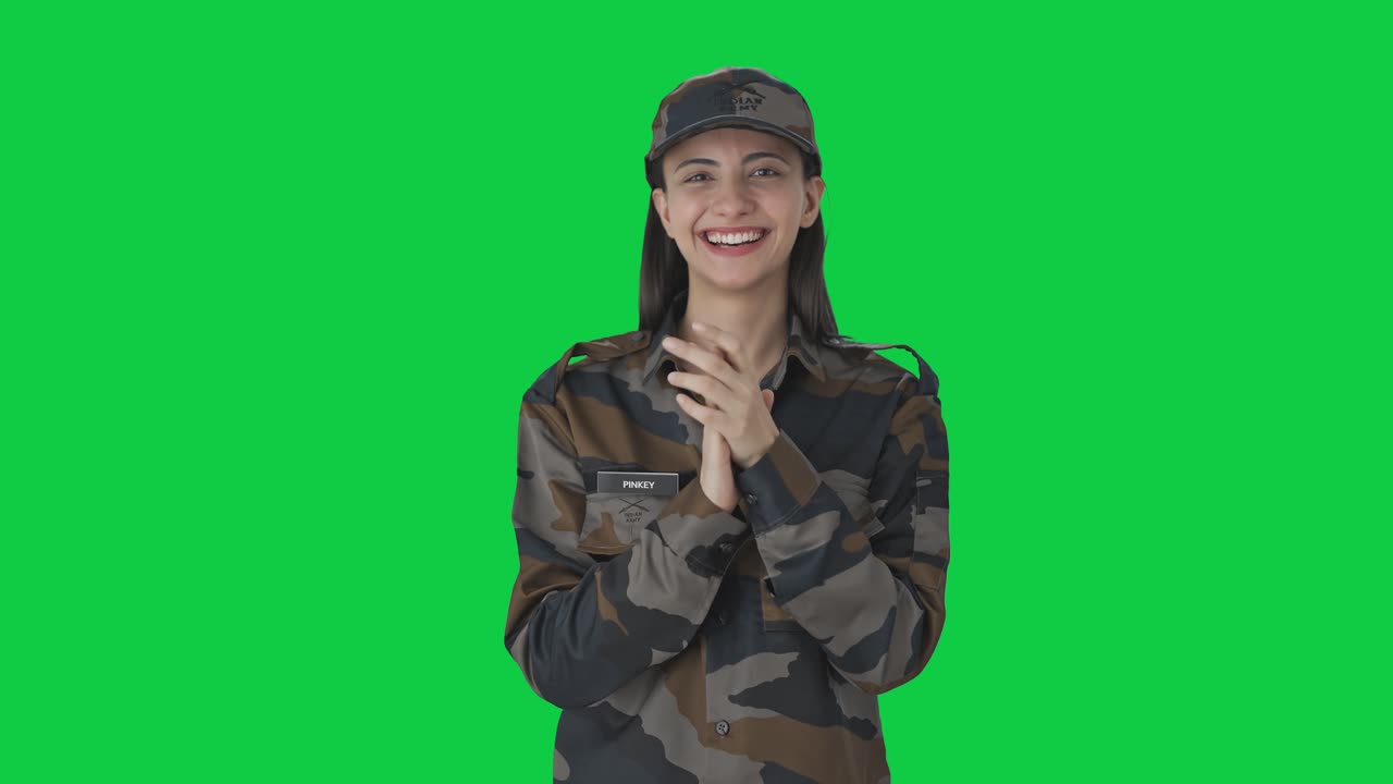 Happy Indian woman army officer clapping and appreciating Green screen