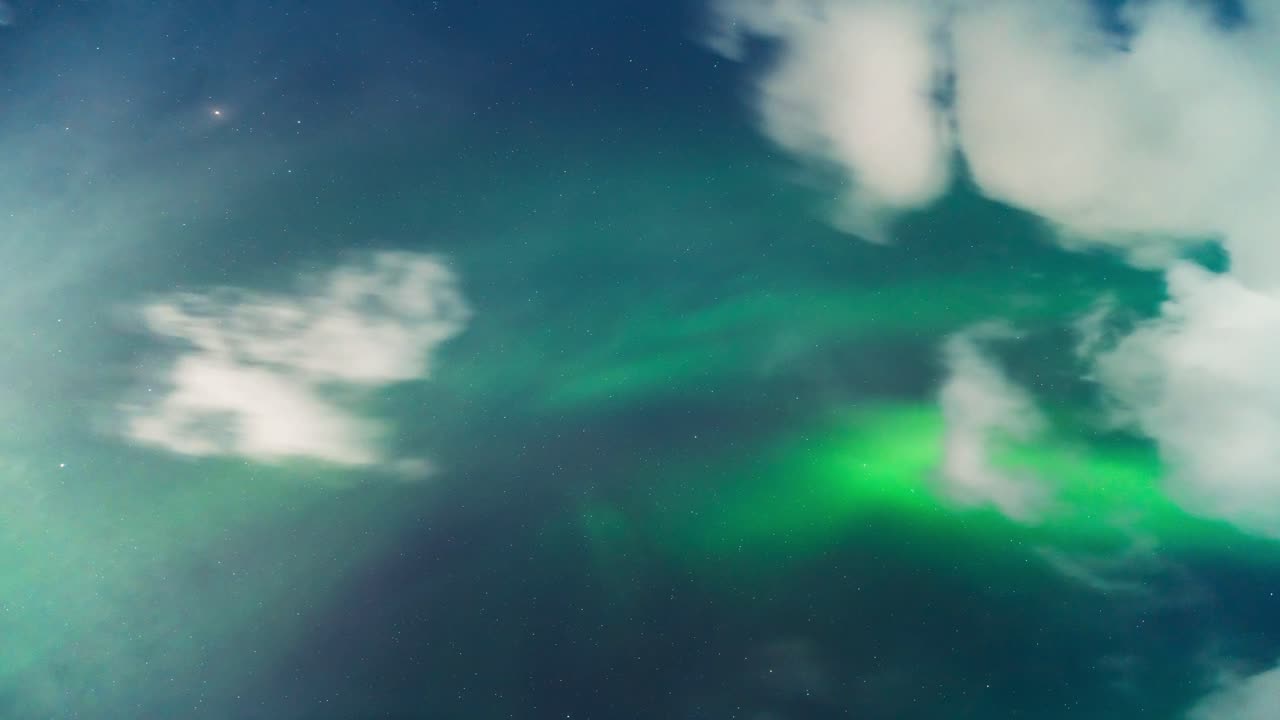 Aurora borealis dances over Tromsø fjords in a stunning timelapse night sky view
