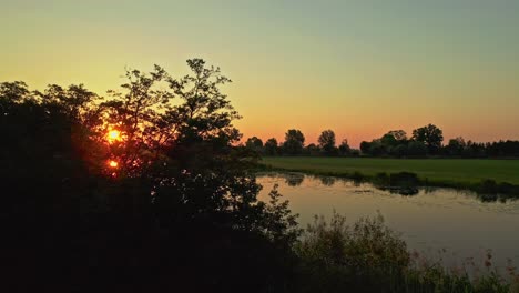 sunrise reveal drone aerial shot on reflective lake