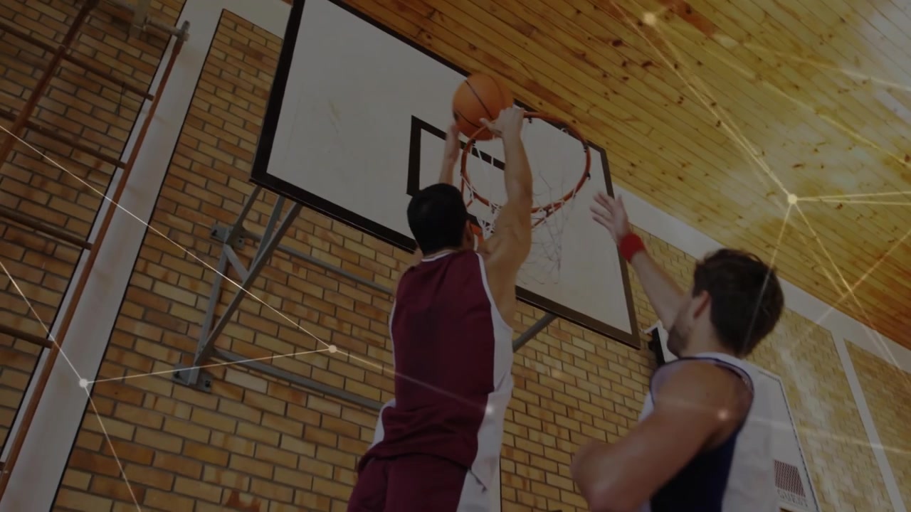 Maroon player getting ball, pivoting, driving toward rim to score, sports overlaying across action