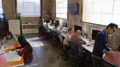 elevated view of people working in modern design office shot on r3d