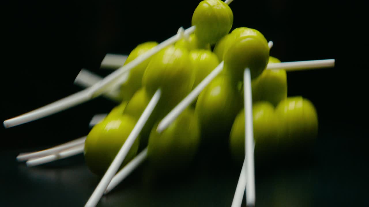 Green lollypop candies rotating. Broll detail shot. Blur effect.
