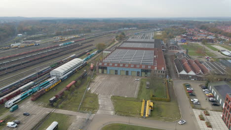 aerial tilt down of old factory on trainyard