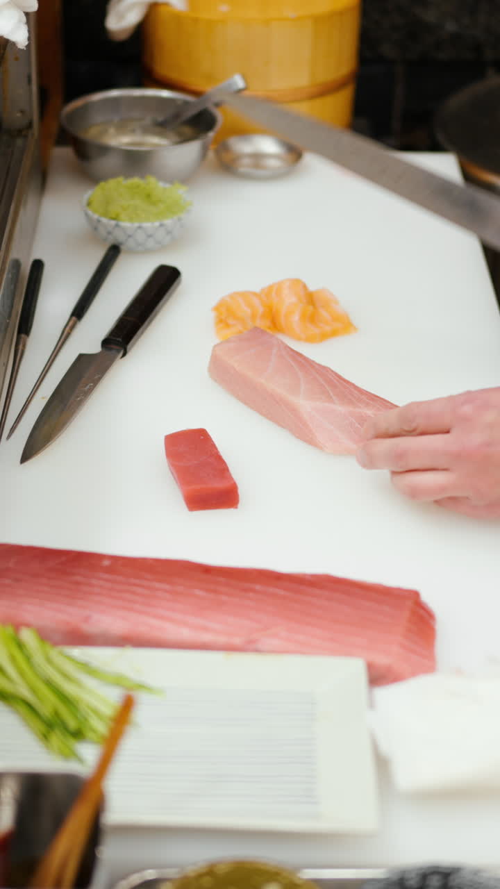 Close up of a chef cutting fish at the Tsukiji Fish Market in Japan. Vertical