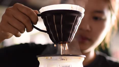 an intimate moment of brewing: a close-up of a person skillfully preparing coffee with precision and care, capturing the essence of artisan techniques