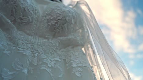 close-up view of the bride's wedding dress on a sunny morning