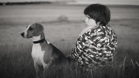 4k outdoor seaside child and dog looking at sunset, black and white