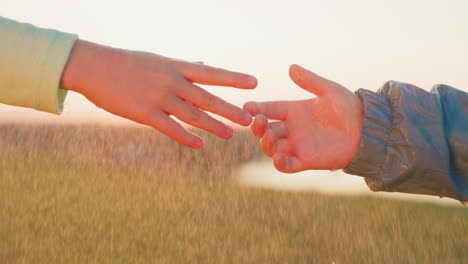 boy and girl intertwine fingers on rainy day children find solace in each other company with