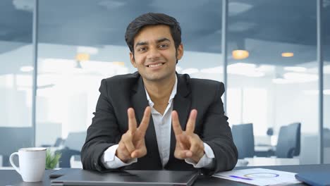 Happy-Indian-businessman-showing-victory-sign