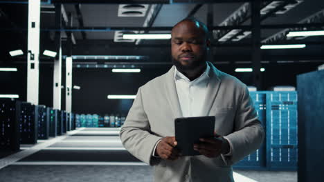 vertical video server room technician doing troubleshooting using tablet to prevent downtime