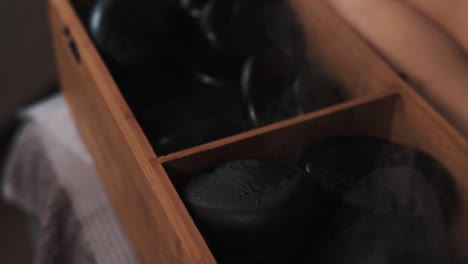 Close-up-of-steaming-hot-black-massage-stones