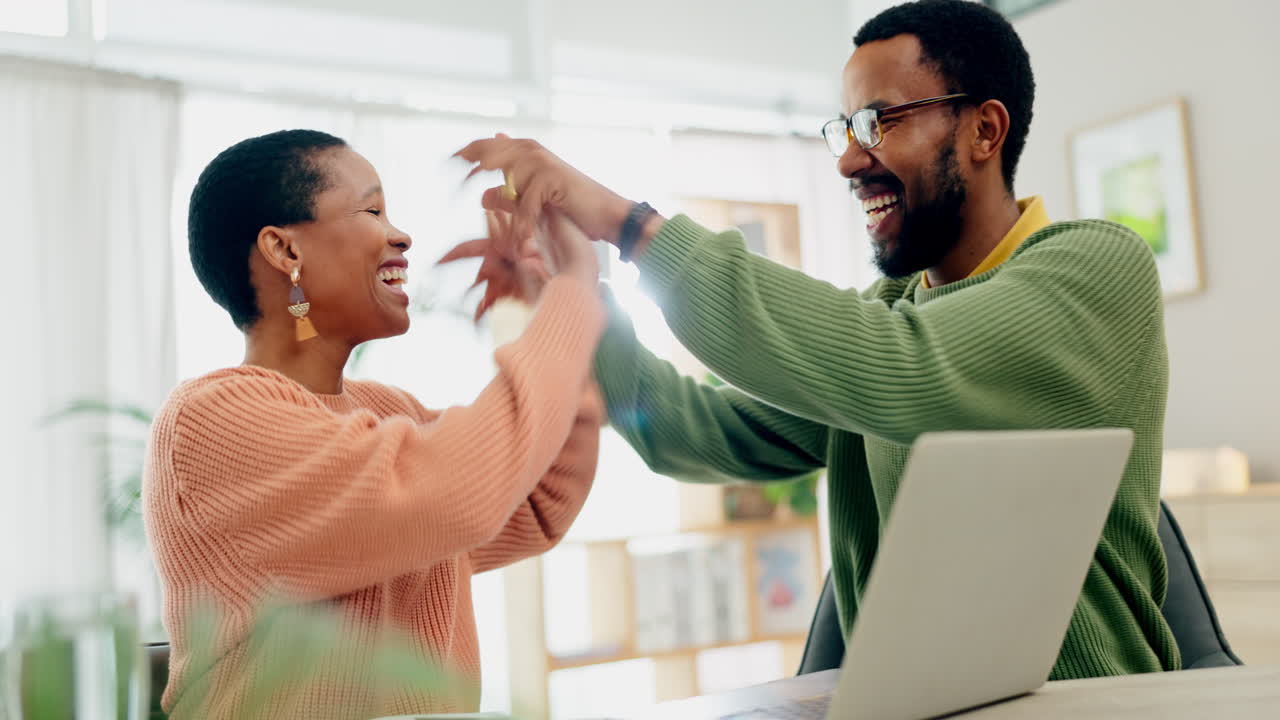 Couple, laptop and winning with high five