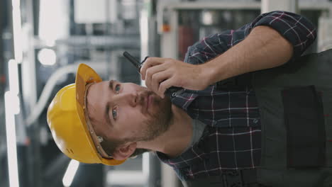 workman using walkie-talkie at factory