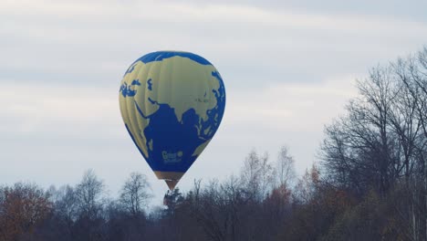 hot air balloon low flight over autumn fall trees