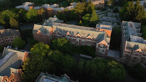 orbiting aerial of the university of washington's communication building during golden hour