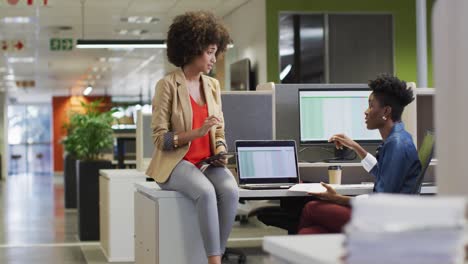 video of diverse businesswomen working on project and using laptop