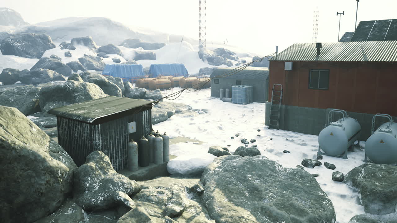 Remote arctic research facility surrounded by snow and rocky terrain