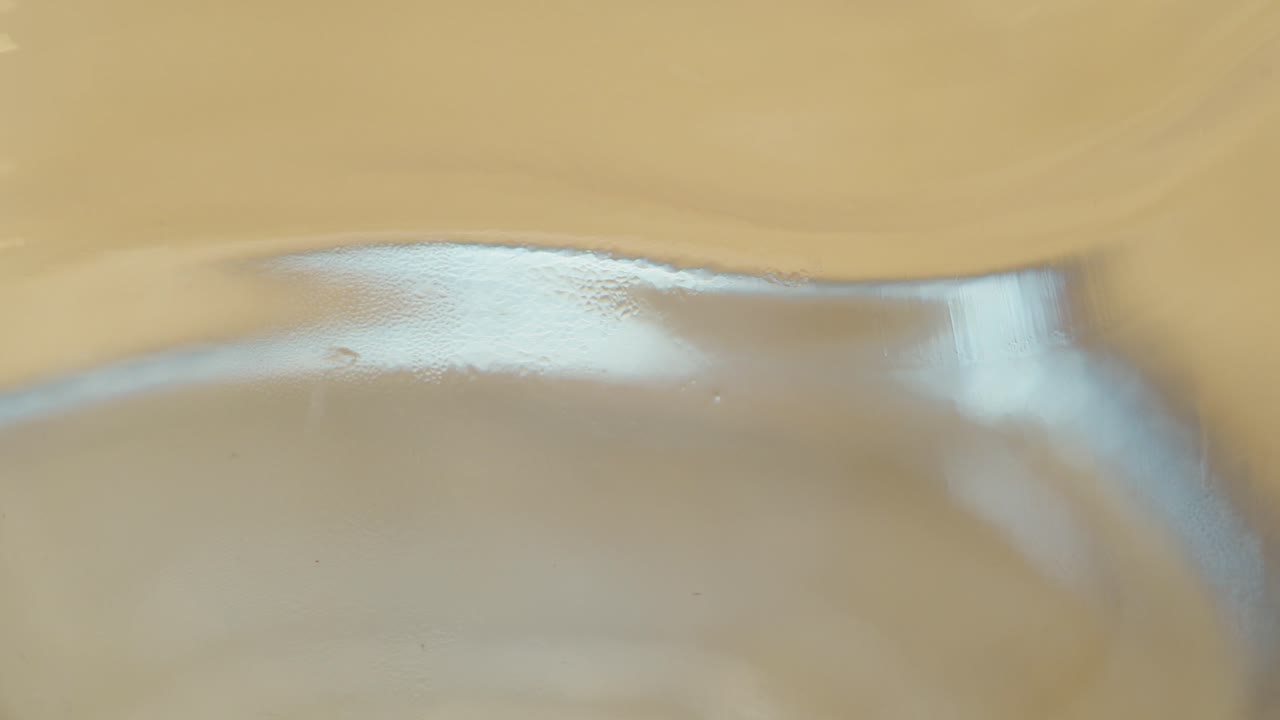 Detailed macro of a metallic spoon reflecting soft light and subtle surface texture. Ideal for design, culinary, or abstract visual use