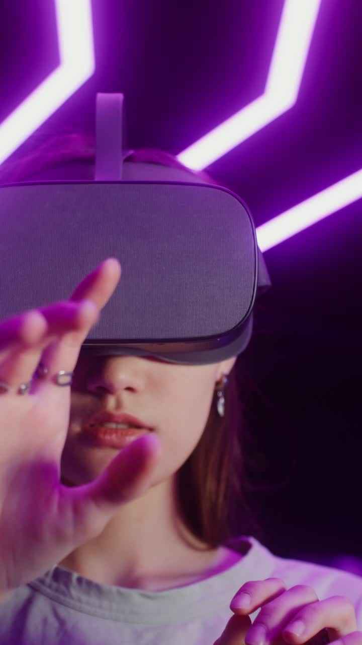 Woman Using VR Headset in Purple Lit Environment