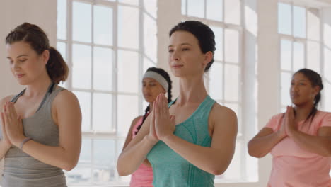 yoga class of young multiracial people practicing prayer pose enjoying healthy spiritual lifestyle exercising in fitness studio training posture