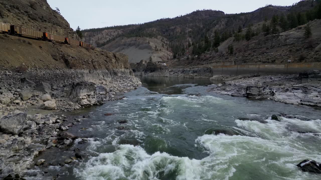 4K CPKC Train alongside the Fraser River in British Columbia. Outside of Boston Bar