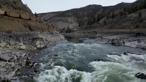4k cpkc train alongside the fraser river in british columbia. outside of boston bar