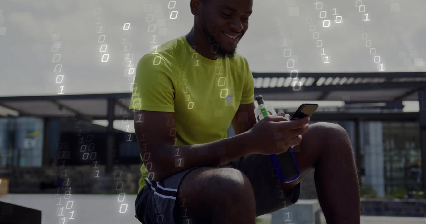 Man sitting on bench foot on basketball tapping phone for sports, causing binary overlay, smiling