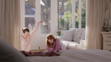 happy teenage girls practicing ballet dance moves in bedroom best friends having fun rehearsal on weekend morning wearing pajamas