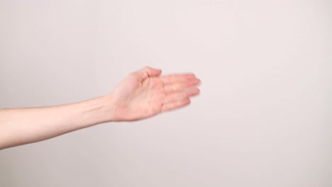 a hand on the left side doing rock paper scissors on a white background