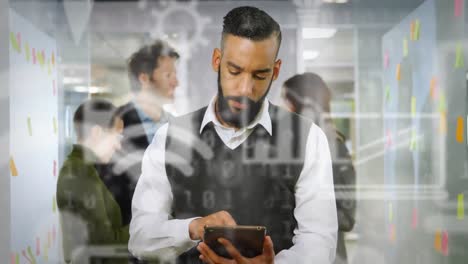 Animation-of-network-of-digital-icons-over-businessman-using-tablet-computer