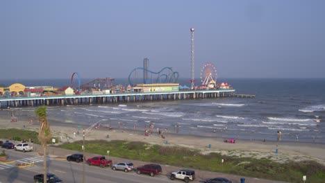 Drone-view-of-the-Pleasure-Pier-and-Galveston-Beach-in-Galveston,-Texas