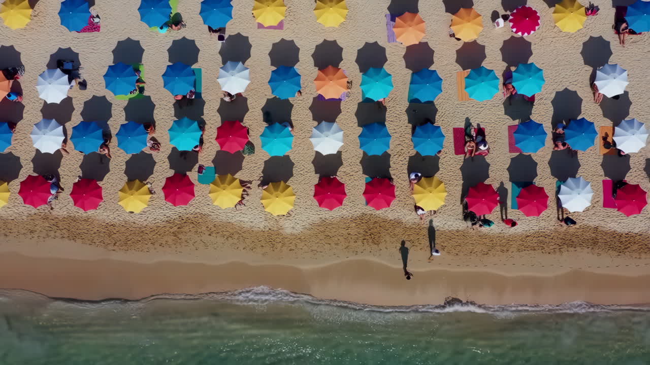 Aerial View of a Crowded Beach with Colorful Umbrellas