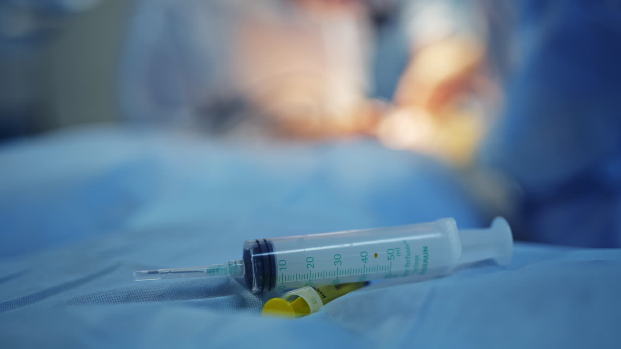Instrumental Surgical In Operating Room. Plastic syringe on the table.