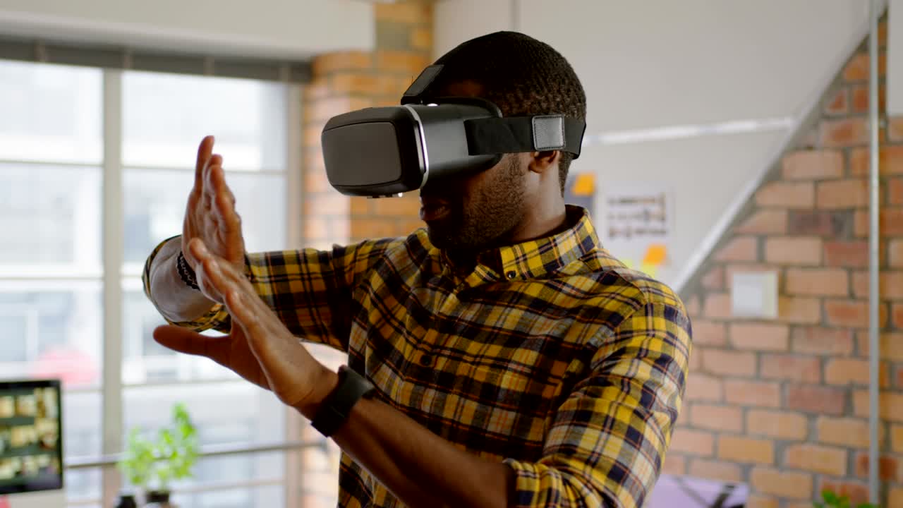 Male graphic designer using virtual reality headset in office 4k