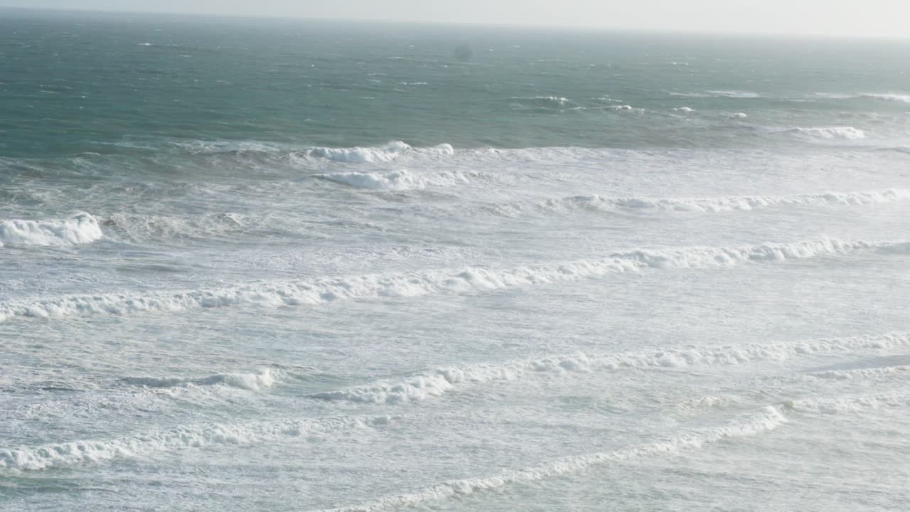 Dynamic ocean waves crash along the Great Ocean Road in Melbourne, captured under soft, natural lighting with a steady camera
