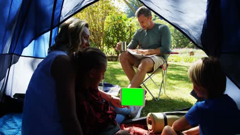 kids and mother using tablet while father looking at the map 4k