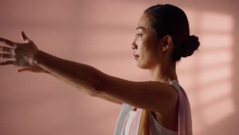 a synchrony of grace: capturing the artistic journey of a woman in fluid motion against a softly colored backdrop with subtle light play