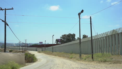 Dirt-road-next-to-the-international-border-between-Mexico-and-USA,-near-San-Ysidro-California