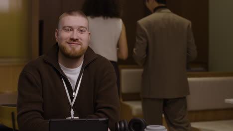 man at conference with tablet and headphones