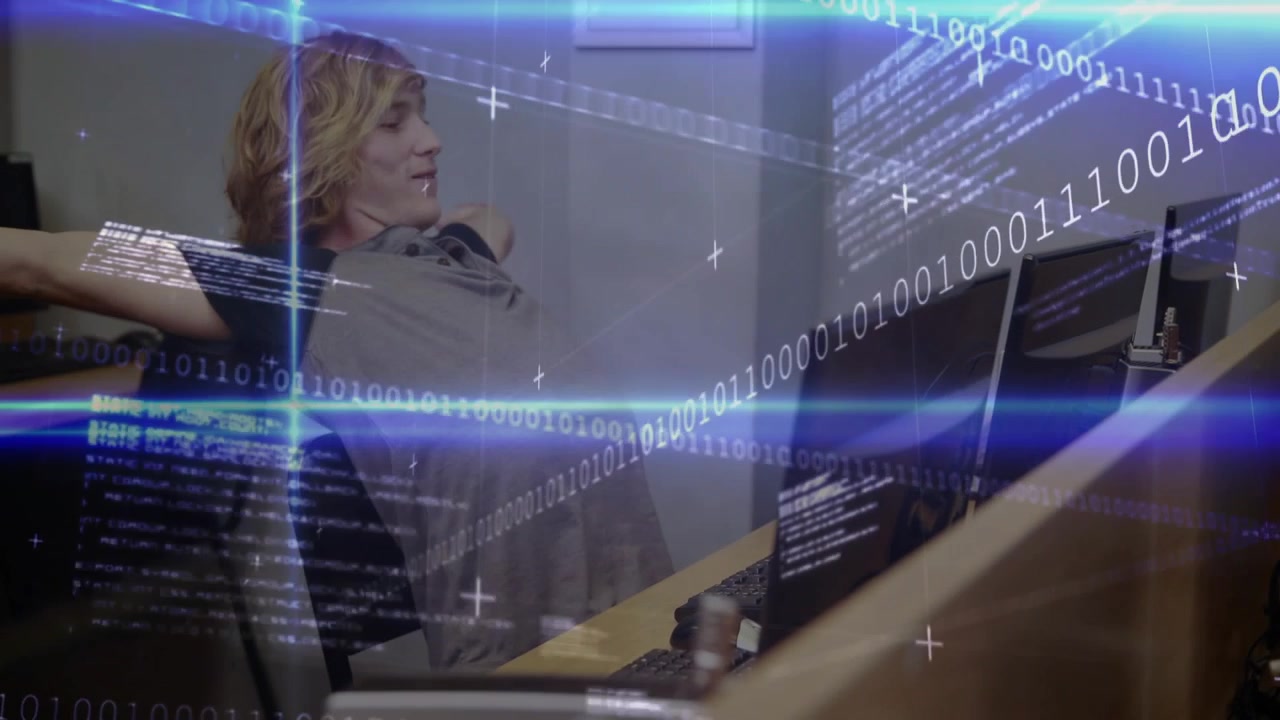 Developer typing code at monitors initiating stretch overlay easing tension then resuming coding