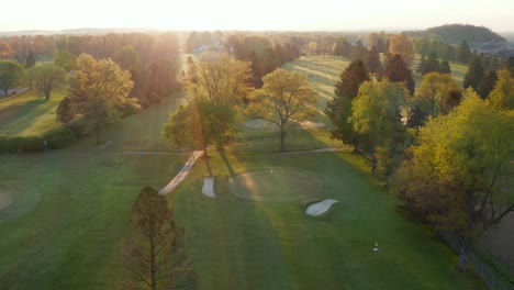 descending aerial on golf course green and fairway at pin and hole