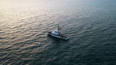 aerial view of coastguard offshore patrol vessel at sunset in coast of usa