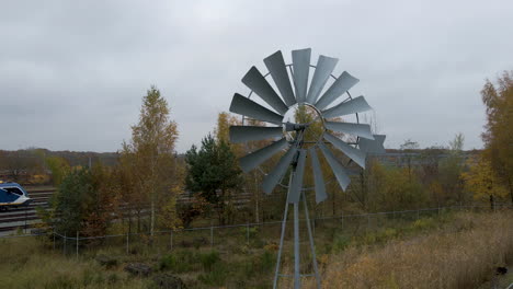 dolly in of old metal windmill spinning fast in the wind