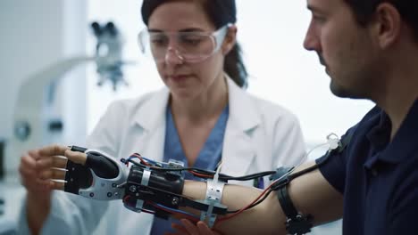 innovative prosthetics: a healthcare professional demonstrates advanced robotic arm technology to enhance patient mobility and quality of life