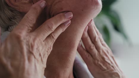 close up of senior woman checking skin condition around the neck