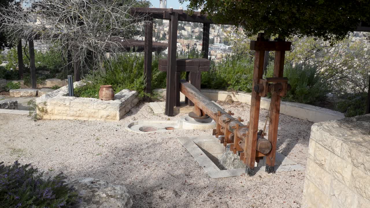 Replica lever-and-weights wooden and stone olive press used anciently - Jerusalem, Israel