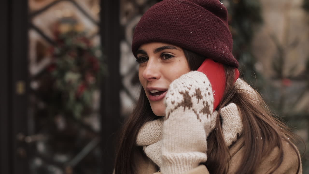 Woman in winter clothing talking on phone