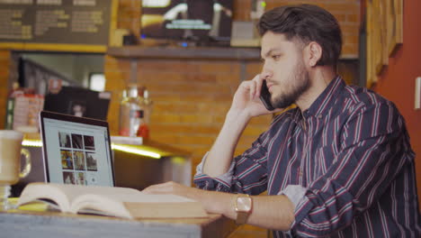 handsome guy using cellphone in a cafe shop