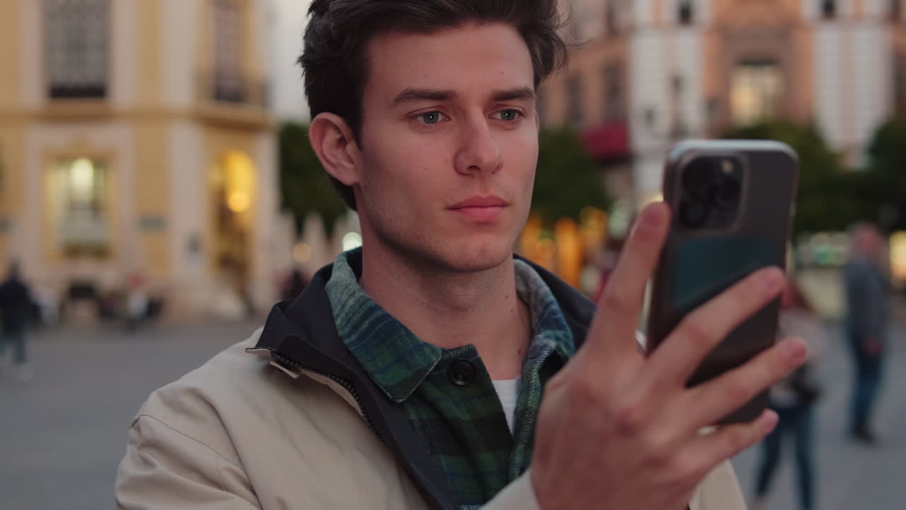Man Taking Photos With Smartphone in Seville